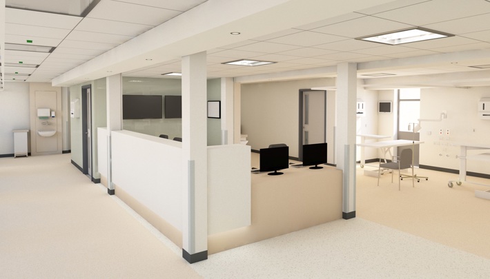 A photograph of an area of the new SDEC - which shows a desk/ station area where staff would be able to sit to carry out work. The area is decorated in cream and white and computer monitors are visible on the desk.